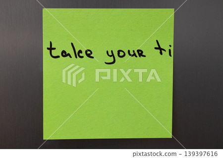 Take your time reminder note on a bright green sticky paper Take your time reminder note on a bright green sticky paper 139397616
