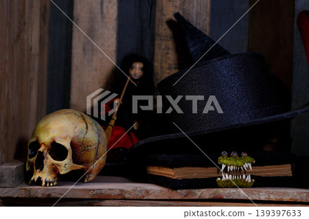 Spooky Halloween scene with a skull, witch hat, and creepy doll Spooky Halloween scene with a skull, witch hat, and creepy doll 139397633