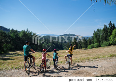 Active family enjoying biking adventure in scenic landscape. Active family enjoying biking adventure in scenic landscape. 139398000