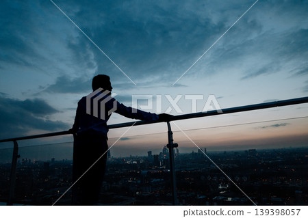 Man with evening skyline of London. Man with evening skyline of London. 139398057
