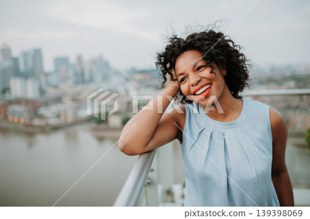 Portrait of a beautiful woman standing on terrace of modern building. Portrait of a beautiful woman standing on terrace of modern building. 139398069