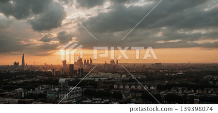 London skyline at sunset with dramatic clouds over city panorama. London skyline at sunset with dramatic clouds over city panorama. 139398074