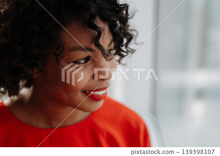A portrait of woman standing by the window against London view panorama. A portrait of woman standing by the window against London view panorama. 139398107