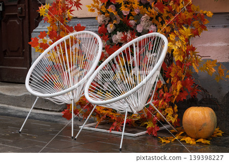 Autumn porch decoration with white chairs and pumpkin Autumn porch decoration with white chairs and pumpkin 139398227
