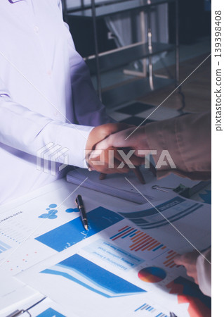 Above table with finance papers, graphs and big data during teamwork meeting with accounting or marketing team discussing budget, strategy or growth development. Closeup of SEO team doing research Above table with finance papers, graphs and big data during teamwork meeting with accounting or marketing team discussing budget, strategy or growth development. Closeup of SEO team doing research 139398408
