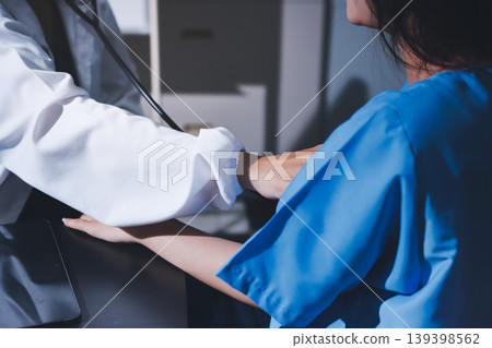 healthy concept; Doctor checking patient's heart with stethoscope at a hospital healthy concept; Doctor checking patient's heart with stethoscope at a hospital 139398562
