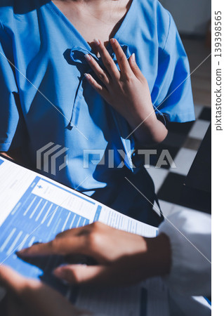 healthy concept; Doctor checking patient's heart with stethoscope at a hospital healthy concept; Doctor checking patient's heart with stethoscope at a hospital 139398565