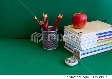 Colorful school supplies on a green background Colorful school supplies on a green background 139399149