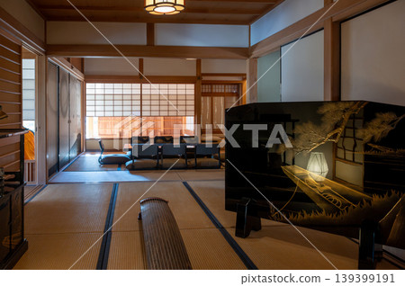 Tranquil tatami area illuminated by gentle morning sunlight and minimal furnishings Tranquil tatami area illuminated by gentle morning sunlight and minimal furnishings 139399191