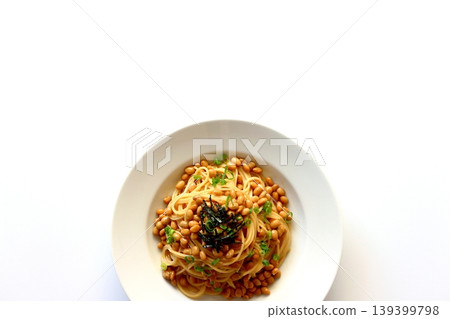 Natto pasta viewed from directly above against a white background. Natto pasta viewed from directly above against a white background. 139399798