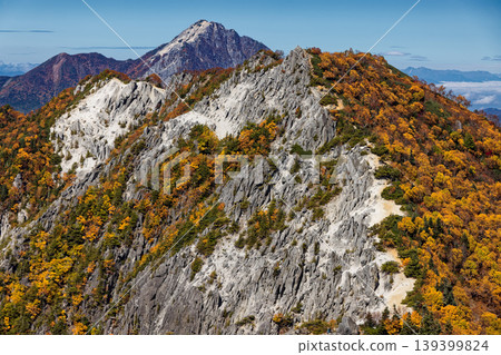Autumn foliage of Akanukizawa-no-atama and Kai-Komagatake as seen from the Kannon-dake ridge of the Houou Sanzan mountain range in the Southern Alps. Autumn foliage of Akanukizawa-no-atama and Kai-Komagatake as seen from the Kannon-dake ridge of the Houou Sanzan mountain range in the Southern Alps. 139399824