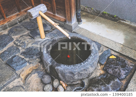 Traditional Japanese Stone Water Basin With Bamboo Ladle Nov 27 2025 Traditional Japanese Stone Water Basin With Bamboo Ladle Nov 27 2025 139400185