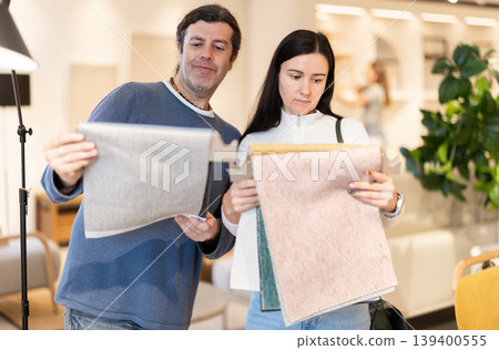 Married couple chooses fabric patterns for upholstery Married couple chooses fabric patterns for upholstery 139400555