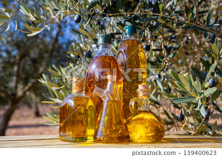 Olive oil on wooden table on background of olive tree Olive oil on wooden table on background of olive tree 139400623