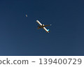 A collaboration of the daytime moon and an airplane. 139400729