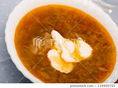 Russian-style cabbage soup Shchi of pork broth with boiled vegetables 139400785
