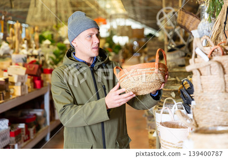 Man choosing decorative wicker basket 139400787