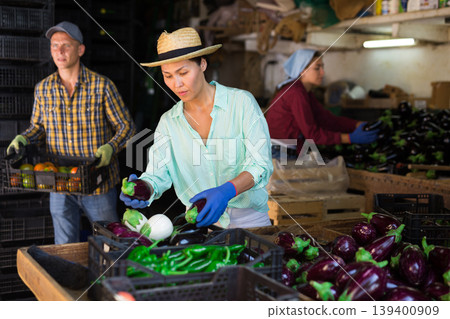 Two women and one man working in warehouse 139400909