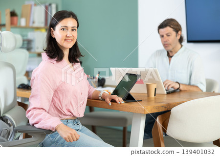 Portrait of business colleagues chatting about work in office Portrait of business colleagues chatting about work in office 139401032