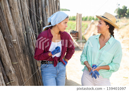 Two female workers talking Two female workers talking 139401097