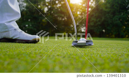 Golfers are putting golf in the evening golf course golf backglound. 139401310