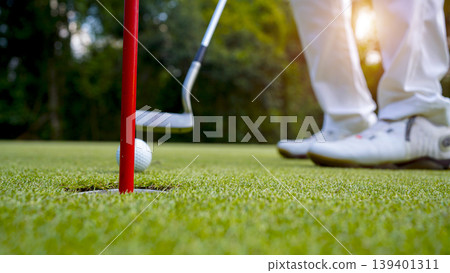 Golfers are putting golf in the evening golf course golf backglound. Golfers are putting golf in the evening golf course golf backglound. 139401311
