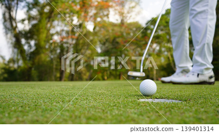 Golfers are putting golf in the evening golf course golf backglound. Golfers are putting golf in the evening golf course golf backglound. 139401314