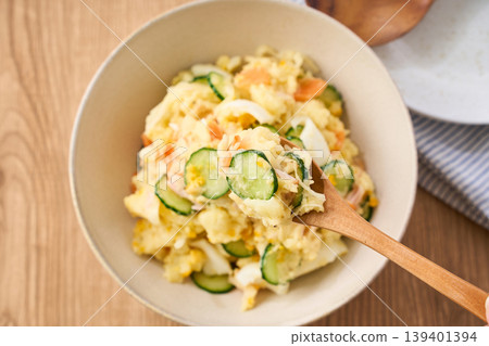 Potato salad, a home-style dish with cucumber, ham, and hard-boiled egg. Potato salad, a home-style dish with cucumber, ham, and hard-boiled egg. 139401394