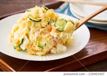 Potato salad, a home-style dish with cucumber, ham, and hard-boiled egg. Potato salad, a home-style dish with cucumber, ham, and hard-boiled egg. 139401407