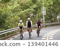young asian people riding bicycle outdoors 139401446