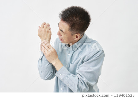 A man with a sore wrist on a white background 139401523