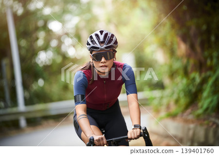 outdoor portrait of young female asian cyclist 139401760