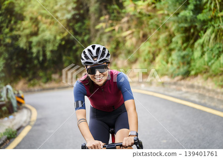 young asian woman riding bike outdoors 139401761