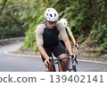 young asian male cyclist riding bicycle outdoors 139402141