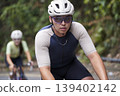 young asian male cyclist riding bicycle outdoors 139402142