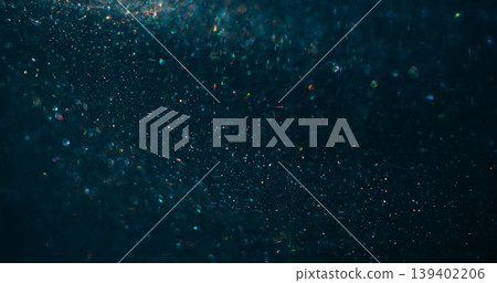 Twinkle bokeh confetti. Flare glimmer. Gradient color mixing light flow. Shimmering blur particles spill on blue black abstract background. Twinkle bokeh confetti. Flare glimmer. Gradient color mixing light flow. Shimmering blur particles spill on blue black abstract background. 139402206