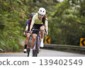 young asian woman riding bike outdoors 139402549