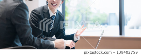 A business image of a sales representative conducting a corporate proposal in an office lounge (faceless). A business image of a sales representative conducting a corporate proposal in an office lounge (faceless). 139402759