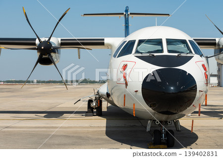 Front view of regional turboprop aircraft with propeller blades 139402831