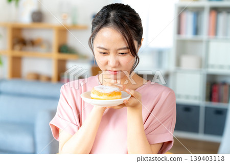 A young woman eating a snack A young woman eating a snack 139403118