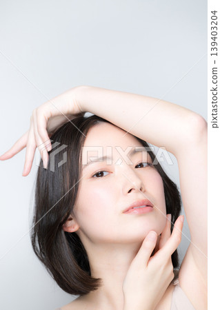 Beauty portrait of a woman with translucent skin: Beautiful skin and skincare beauty, hands, fingertips, and jawline. Beauty portrait of a woman with translucent skin: Beautiful skin and skincare beauty, hands, fingertips, and jawline. 139403204