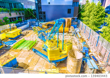 A cityscape of Tokyo, Japan: In front of Shimbashi Station on the Yurikamome Line. Large construction machinery... In the background of the image is the intersection in front of Hibiya Shrine in Higashi-Shimbashi 1-chome. 139403443