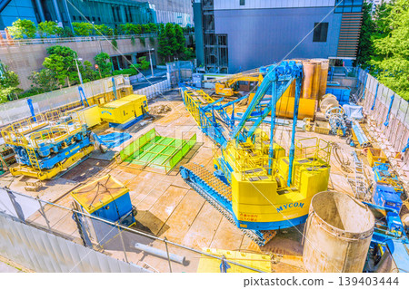 A cityscape of Tokyo, Japan: In front of Shimbashi Station on the Yurikamome Line. Large construction machinery... In the background of the image is the intersection in front of Hibiya Shrine in Higashi-Shimbashi 1-chome. 139403444