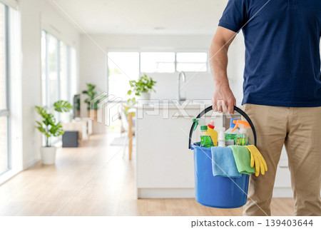 A man holding cleaning supplies – an image of housework. A man holding cleaning supplies – an image of housework. 139403644