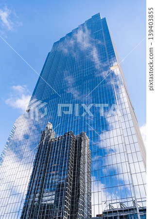 Business skyscraper building. Architectural building in business area. Glass skyscraper. City architecture. Architecture of modern office building. Perspective city skyscraper with reflection 139403855