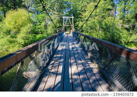 Travel destination. Destination route way. Touristic pathway outdoor. Path way on bridge in forest. Adventure route way path. Concept of wanderlust. Suspension bridge. Touristic trail Travel destination. Destination route way. Touristic pathway outdoor. Path way on bridge in forest. Adventure route way path. Concept of wanderlust. Suspension bridge. Touristic trail 139403872