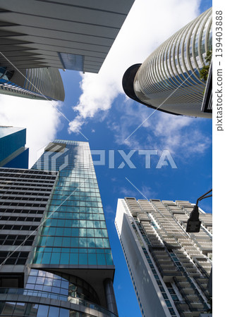 Skyscraper in city downtown. City downtown with skyscraper. Office building in business district. Skyscraper building architecture. Business skyscraper of glass. Modern glass building 139403888