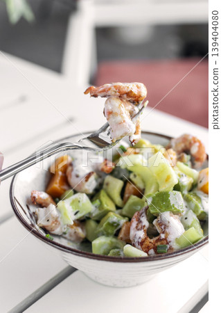 tropical prawn salad with mango and celery on outdoor garden cafe table tropical prawn salad with mango and celery on outdoor garden cafe table 139404080
