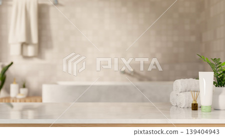 White towel with diffuser and cleanser tube on marble counter table across tub in tile wall bathroom White towel with diffuser and cleanser tube on marble counter table across tub in tile wall bathroom 139404943