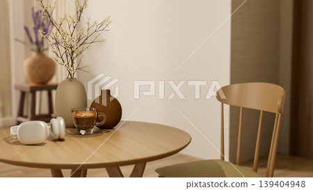 Headphones and coffee cup with flower vase on round wooden table with chair in a modern room or cafe Headphones and coffee cup with flower vase on round wooden table with chair in a modern room or cafe 139404948
